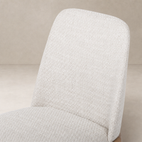 Rhys Armless Dining Chair in Gibson Wheat showcasing textured upholstery and sleek design.