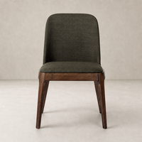 Rhys Armless Dining Chair in Bilton Olive with a sleek design and wooden legs.