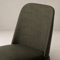 Rhys Armless Dining Chair in Bilton Olive featuring textured fabric and sleek design.