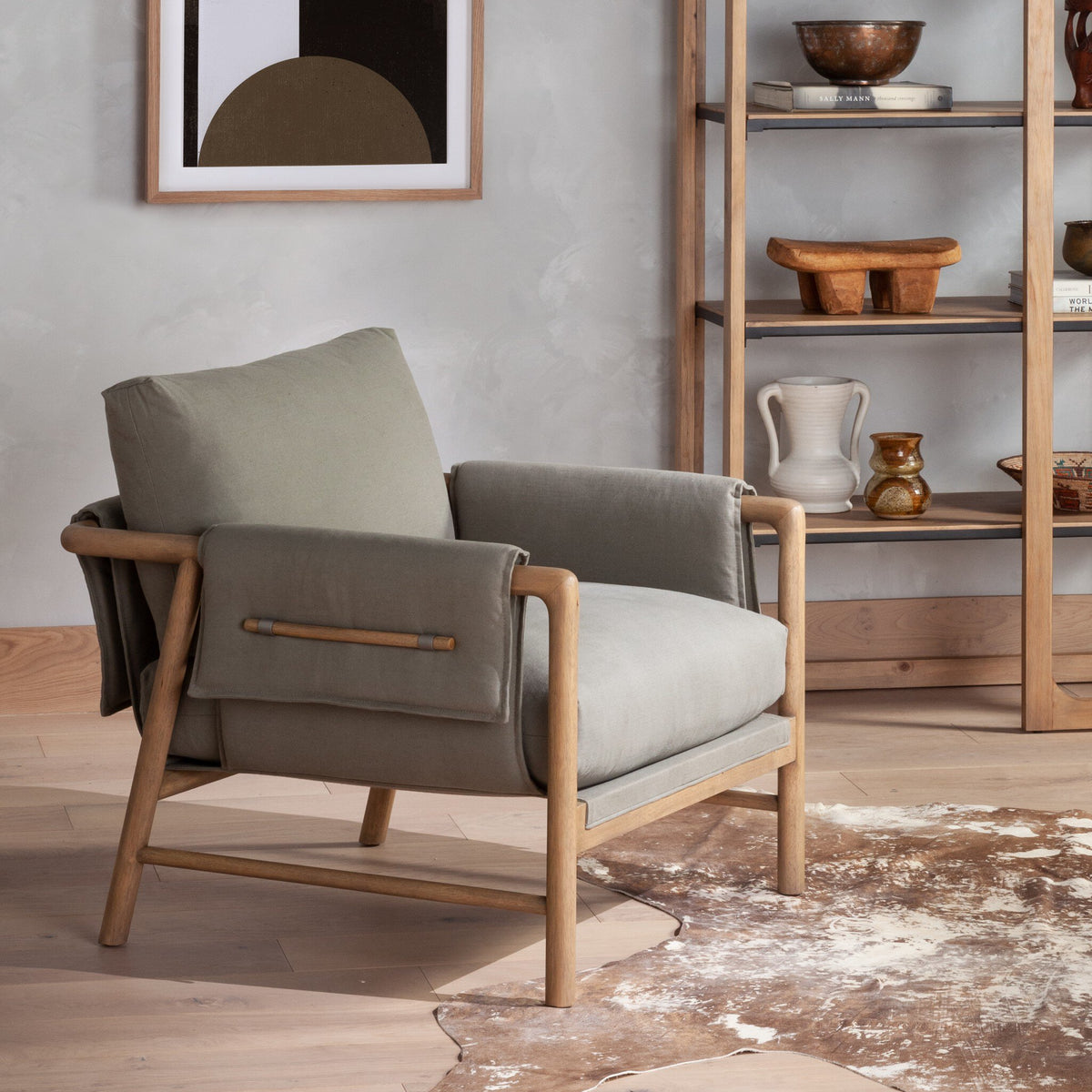 Mykonos Chair in Villa Olive, featuring a modern design and comfortable fabric cushions.