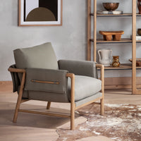 Mykonos Chair in Villa Olive, featuring a modern design and comfortable fabric cushions.