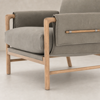 Mykonos Chair in Villa Olive features soft cushions and natural wooden accents.