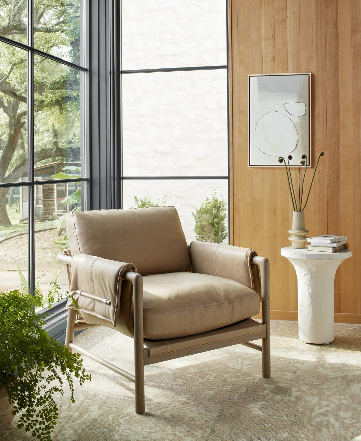 Mykonos Chair in Palermo Nude with sleek lines and cozy cushions in a stylish room setting.