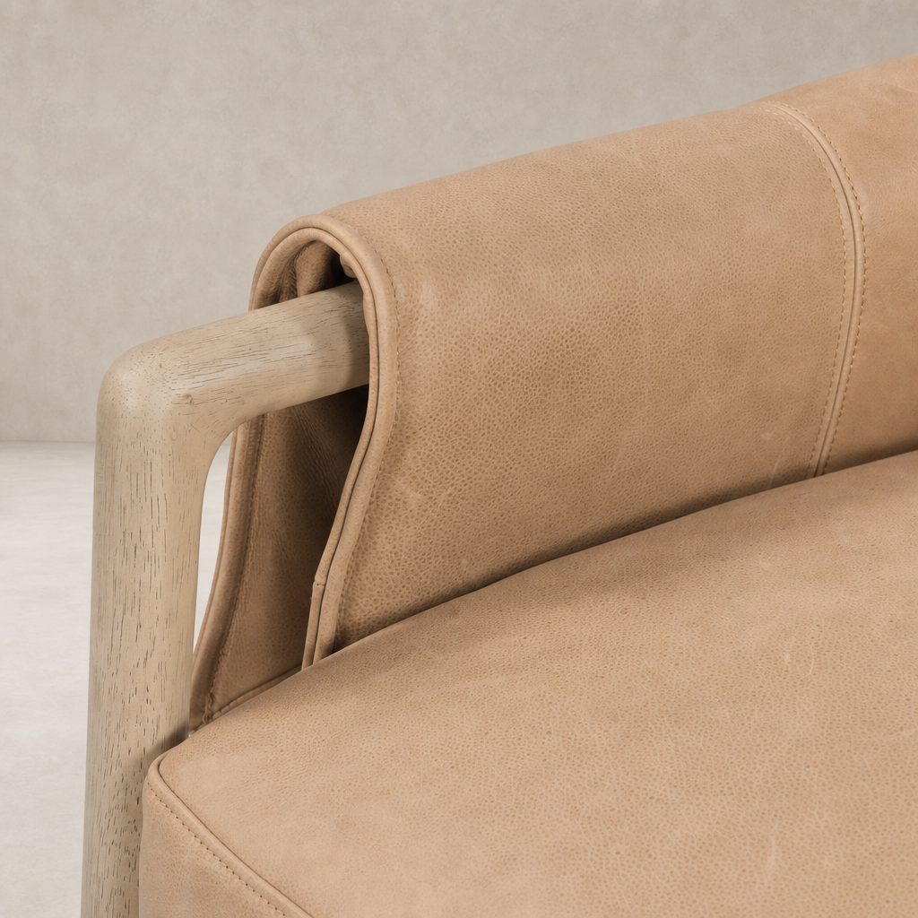 Mykonos Chair in Palermo Nude showcasing soft leather texture and natural wood armrest.
