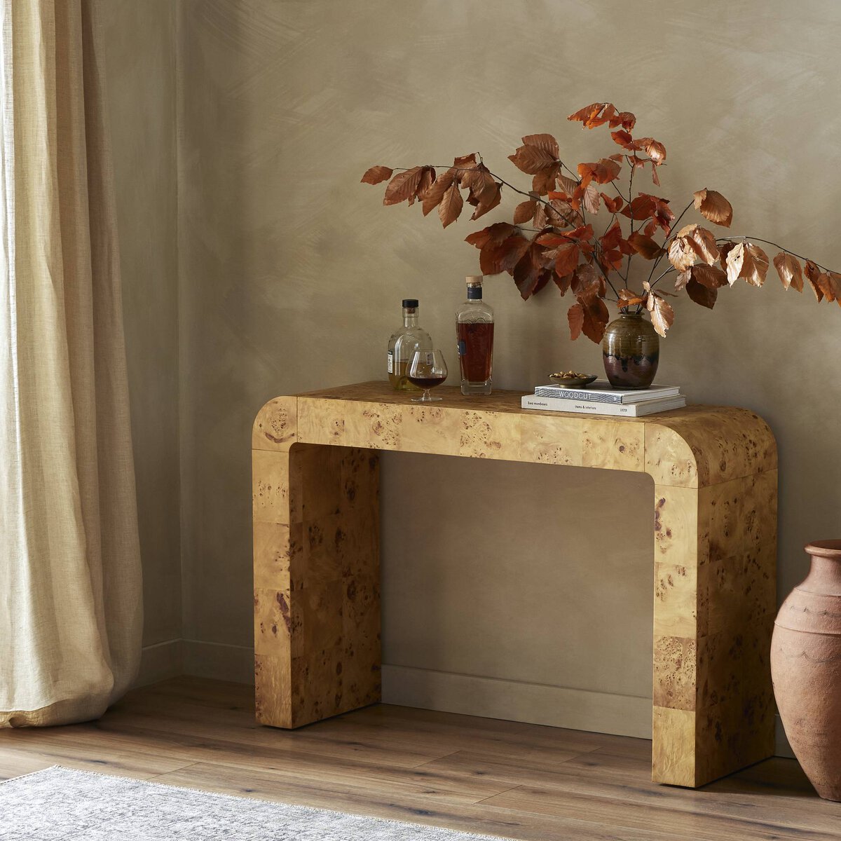 Close-up of the Perrin Console Table showcasing its unique burl wood finish and curved edges.