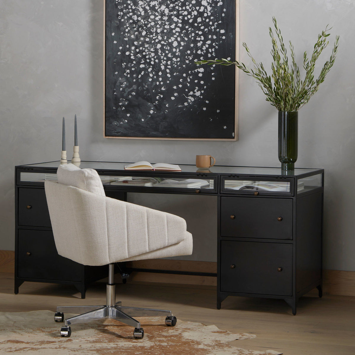 Kestrel Box Executive Desk in black with glass top and bronze hardware, styled in modern office.
