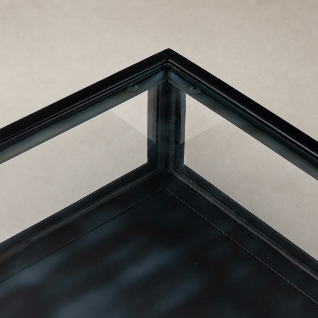 Close-up of the sleek black corner detail of the Kestrel Box Executive Desk.