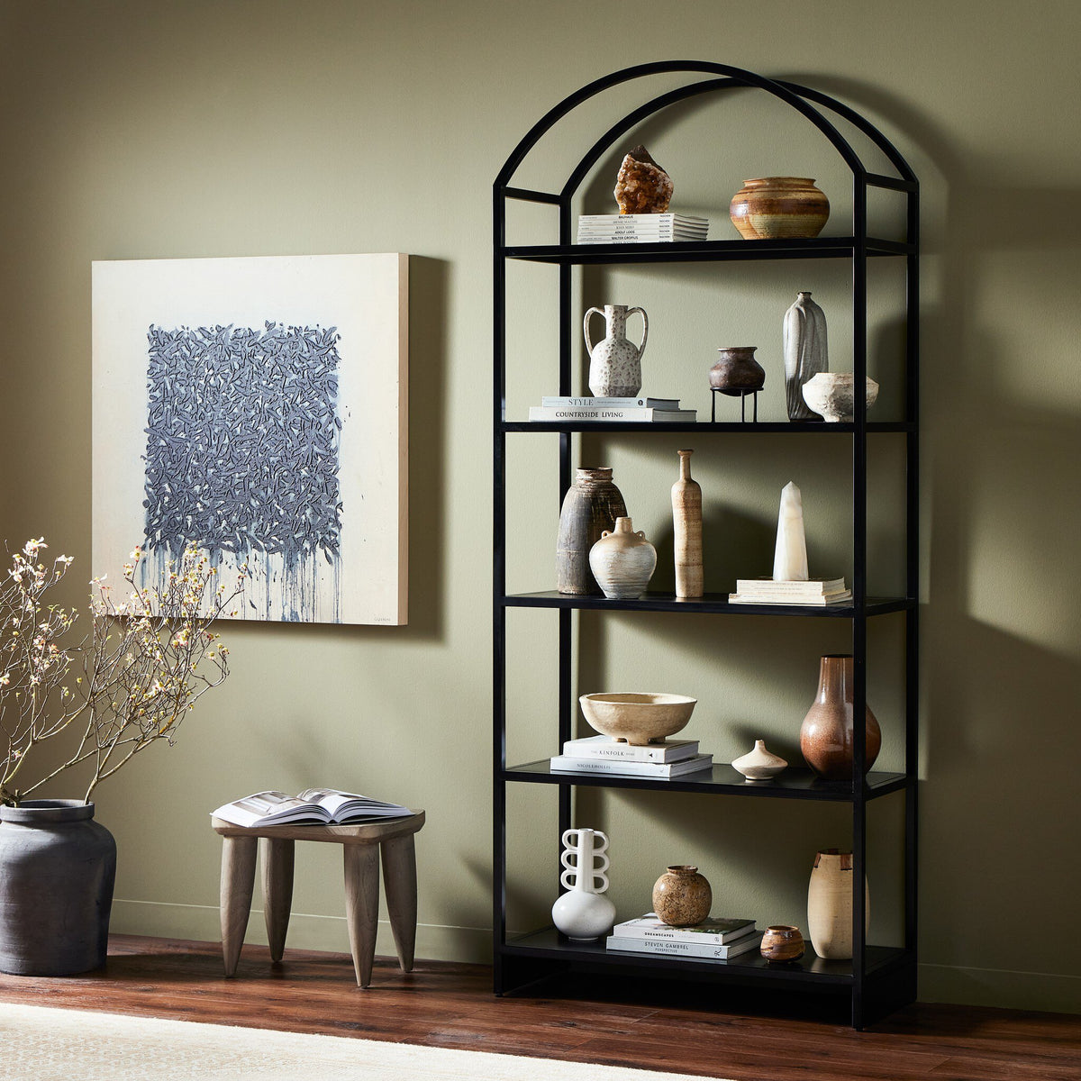 Fez Bookcase in black with an arched top, showcasing elegant decorative items.
