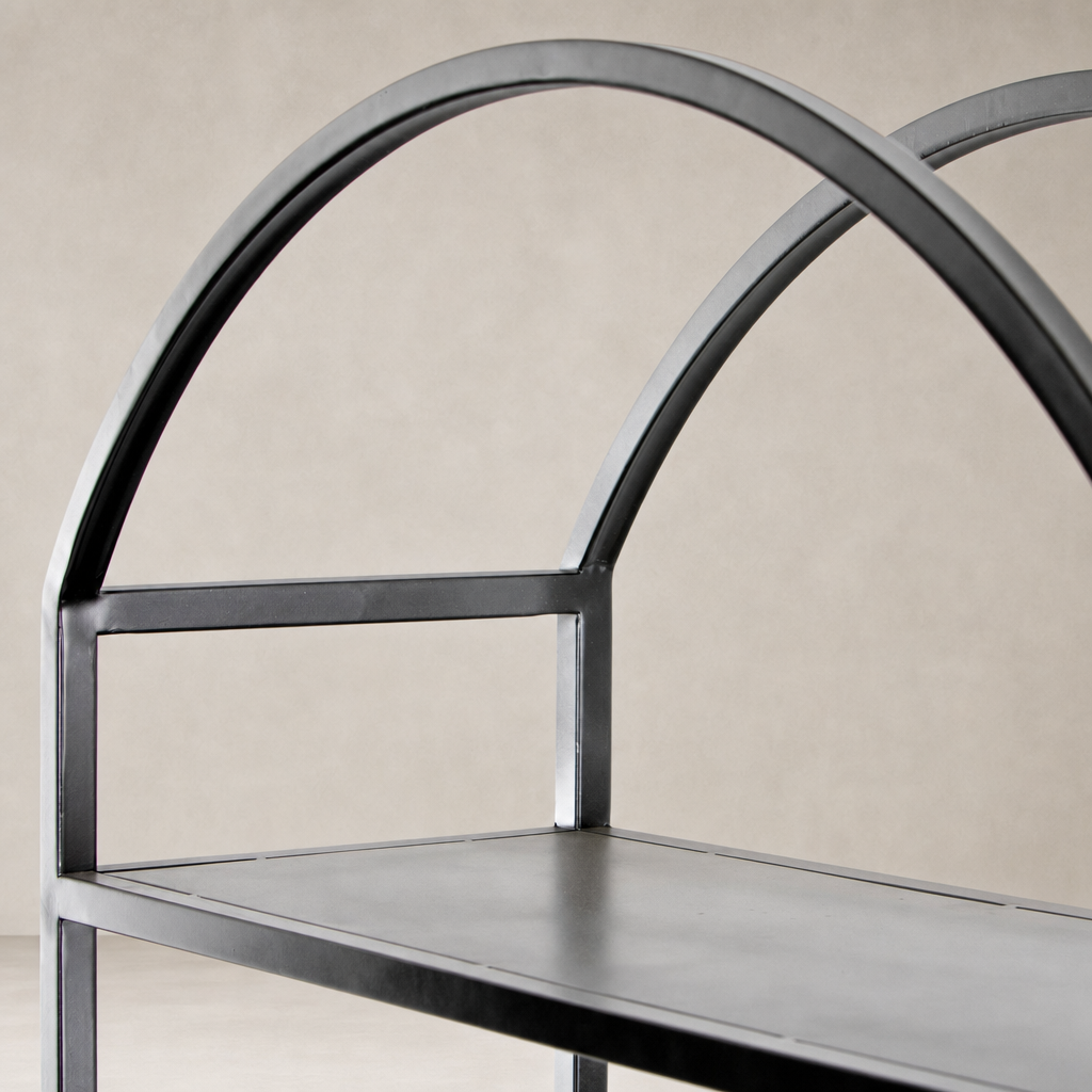 Detailed black metal frame of the Fez Bookcase with an arched design.