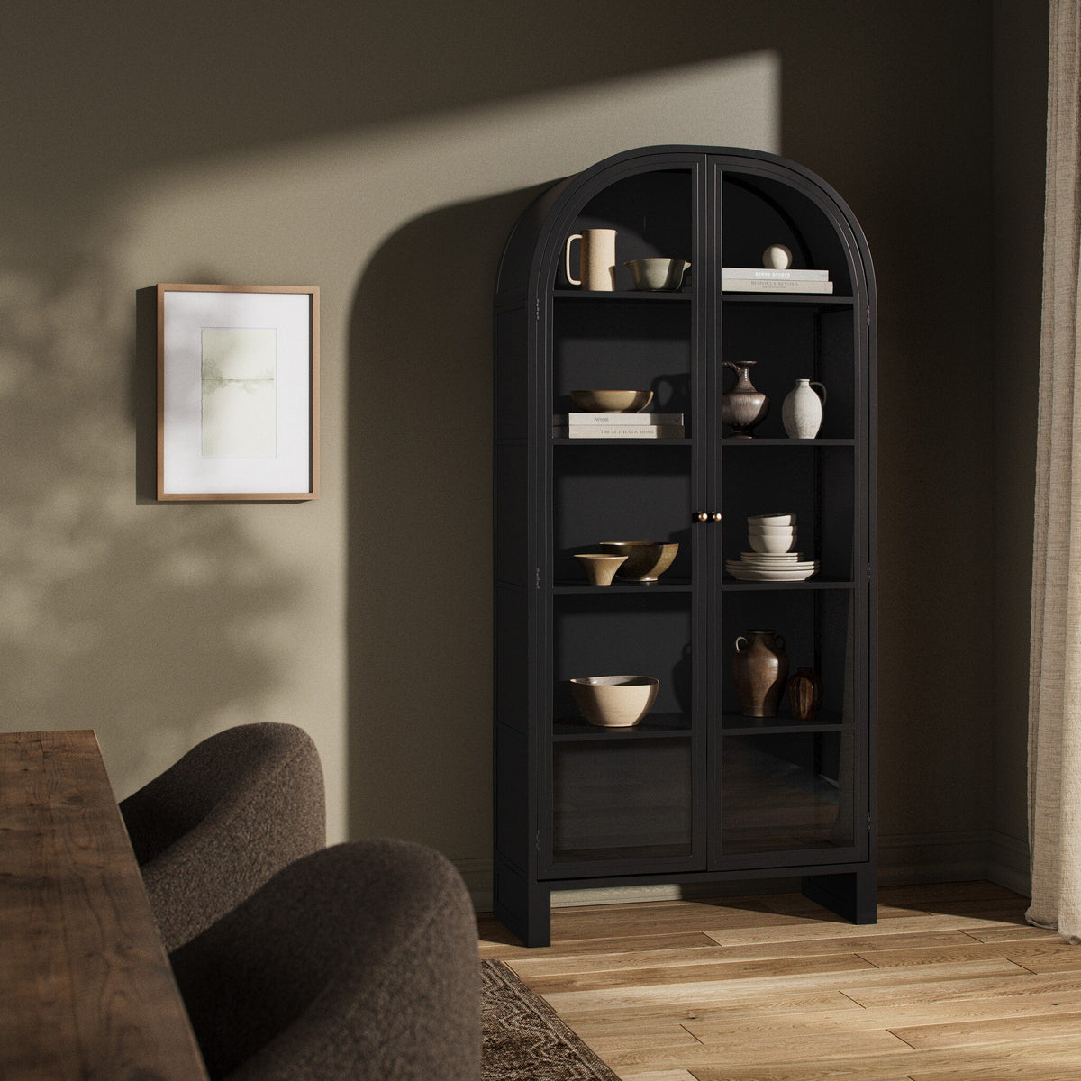 Black Delta Cabinet featuring arched top and glass doors, styled with decorative ceramics.