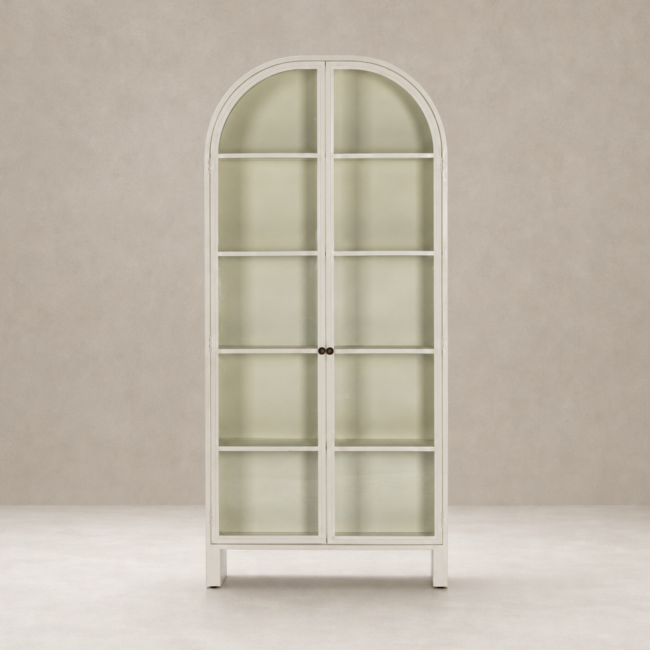 Cream powder coat Delta Cabinet with arched top and glass shelves.