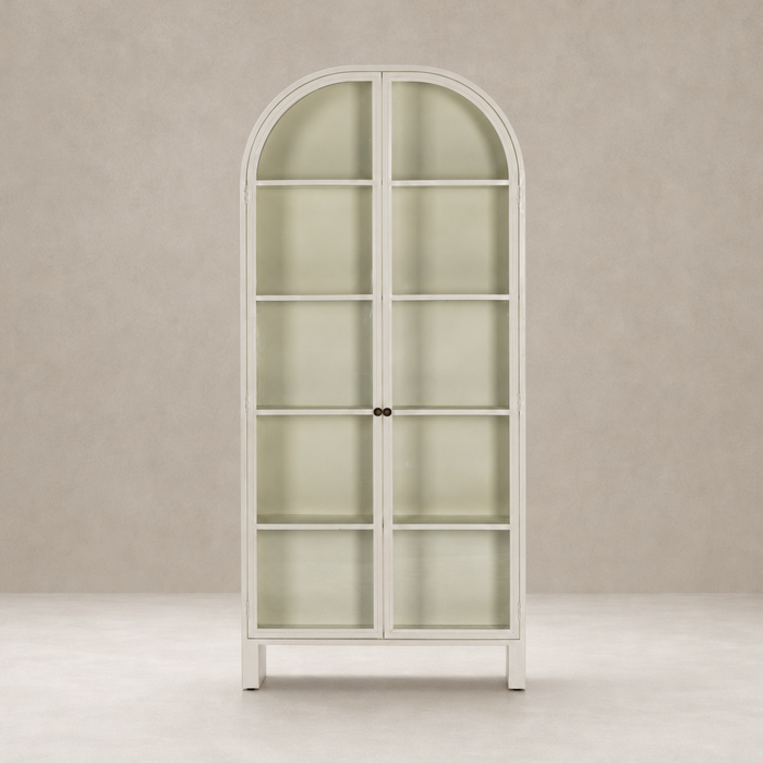 Cream powder coat Delta Cabinet with arched top and glass shelves.