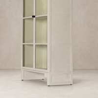 Cream powder coat Delta Cabinet with glass doors and sleek geometric lines.