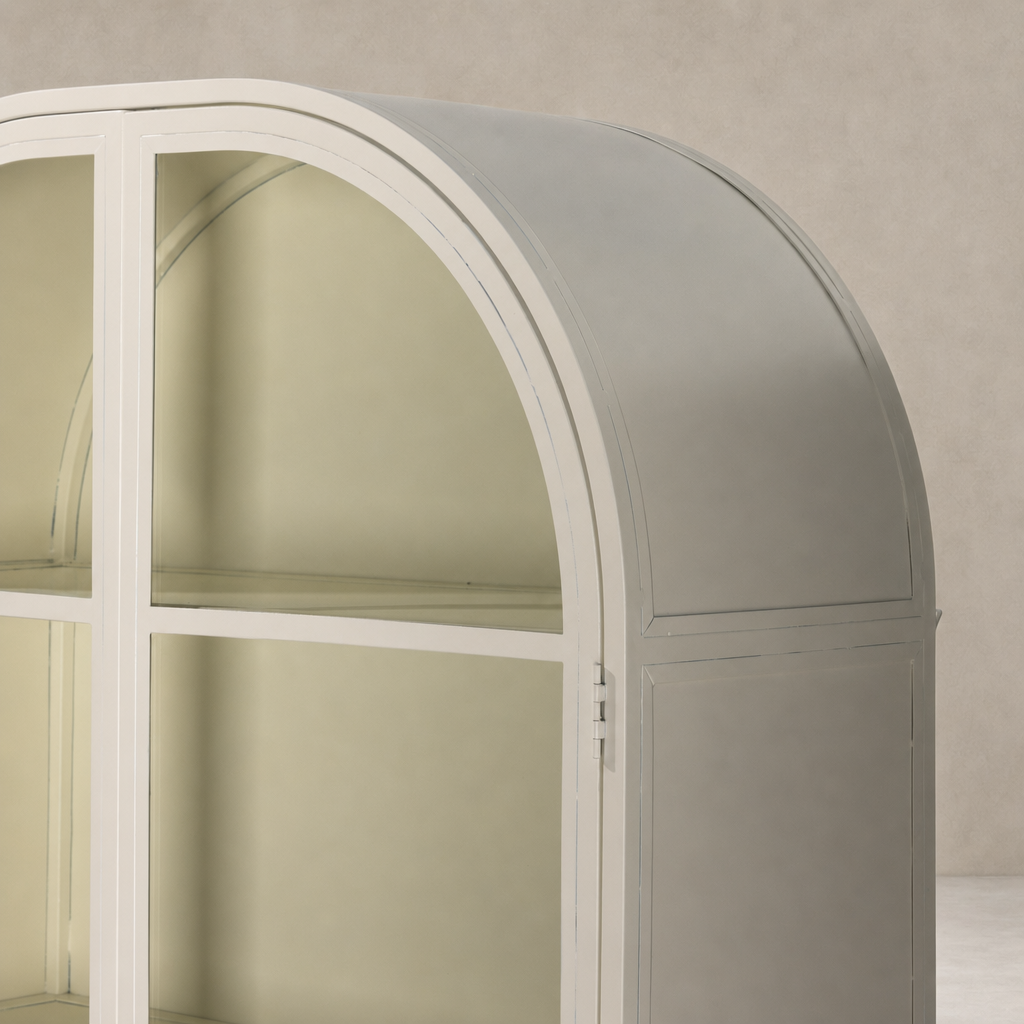 Cream powder coat Delta Cabinet featuring a smooth, rounded top and spacious glass shelves.