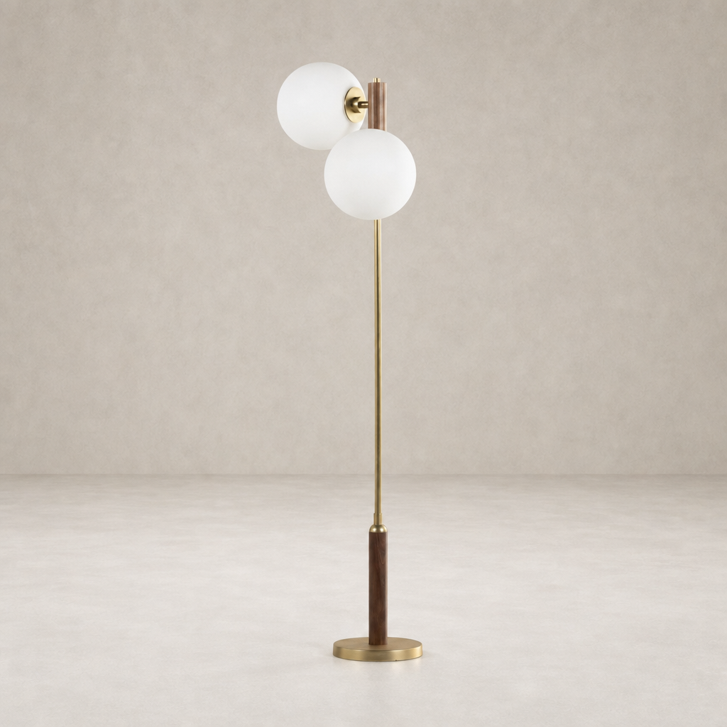 Aged brass floor lamp with white glass globes and a wooden base.