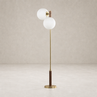 Aged brass floor lamp with white glass globes and a wooden base.