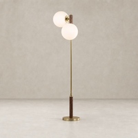 Aged brass floor lamp with two frosted globe shades and wooden base.