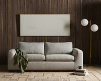Aged brass floor lamp with spherical white shades complementing a modern sofa.