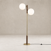 Aged brass floor lamp with dual glass globes and a wooden accent.