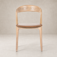 Amato Dining Chair in Sonoma Butterscotch with a curved wooden back and cushioned seat.