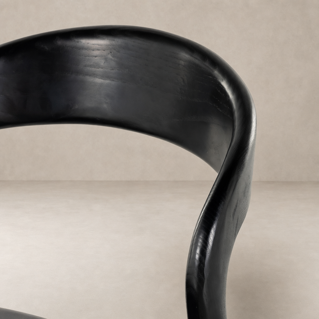 Curved Sonoma Black Amato Dining Chair showcasing smooth, modern lines and a sleek finish.