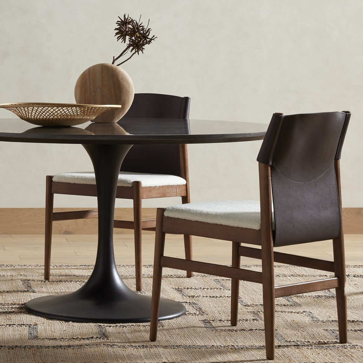 Close-up of the Calais Dining Chair featuring a sleek wood frame and comfortable upholstered seat.