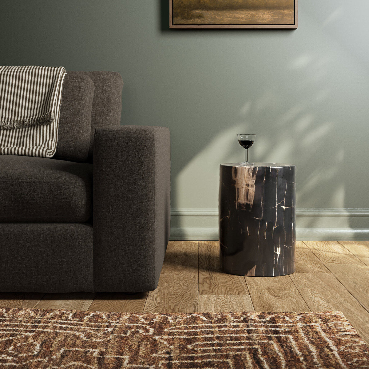Naxos End Table in a sleek cylindrical design, featuring a striking dark finish.
