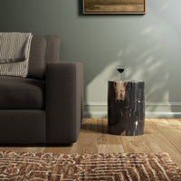 Naxos End Table in a sleek cylindrical design, featuring a striking dark finish.
