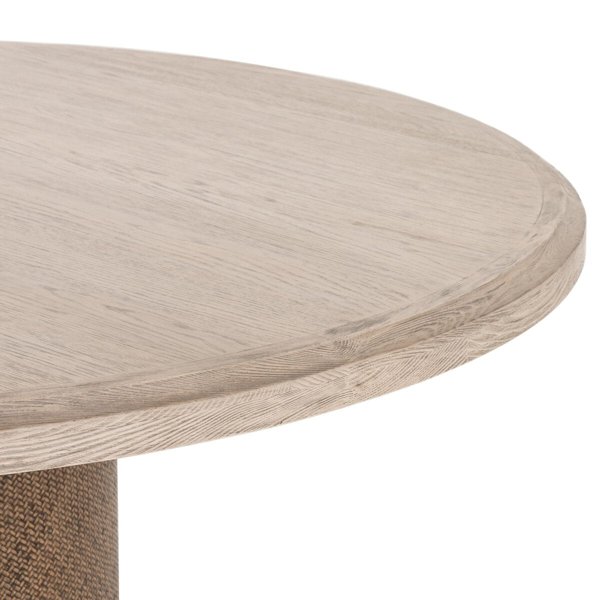 Close-up of the Kaia Round Dining Table showcasing its light wood finish and smooth rounded edges.