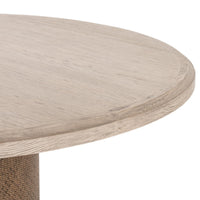 Close-up of the Kaia Round Dining Table showcasing its light wood finish and smooth rounded edges.