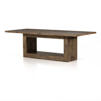 Three-quarter view of the Thalia Dining Table, showcasing its rustic wood finish and open base design.