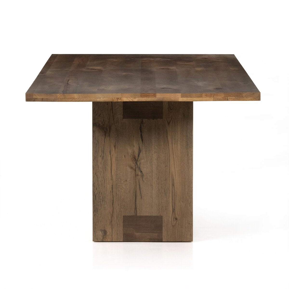 Front view of the Thalia Dining Table, featuring a sleek, square top and sturdy wooden base in a warm finish.