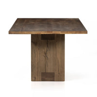 Front view of the Thalia Dining Table, featuring a sleek, square top and sturdy wooden base in a warm finish.