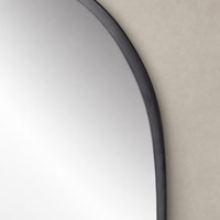 Elena Wide Mirror featuring a matte black iron frame and sleek curved edges.