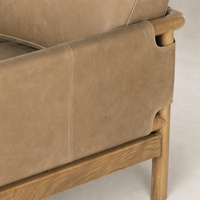 Soleil Chair in Palermo Drift features a textured leather finish and wooden base detail.