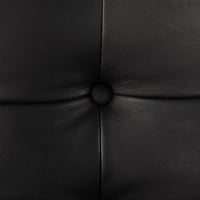Close-up of the Langston Chair's Heirloom Black leather upholstery and tufted detail.