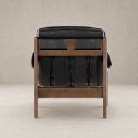 Langston Chair in Heirloom Black with tufted backrest and wood frame.