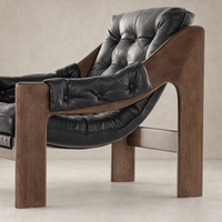 Langston Chair in Heirloom Black featuring a tufted leather seat and wooden frame.