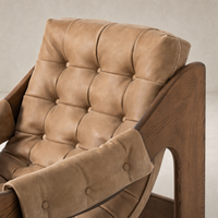 Langston Chair in Palermo Drift featuring tufted upholstery and sleek wooden arms.