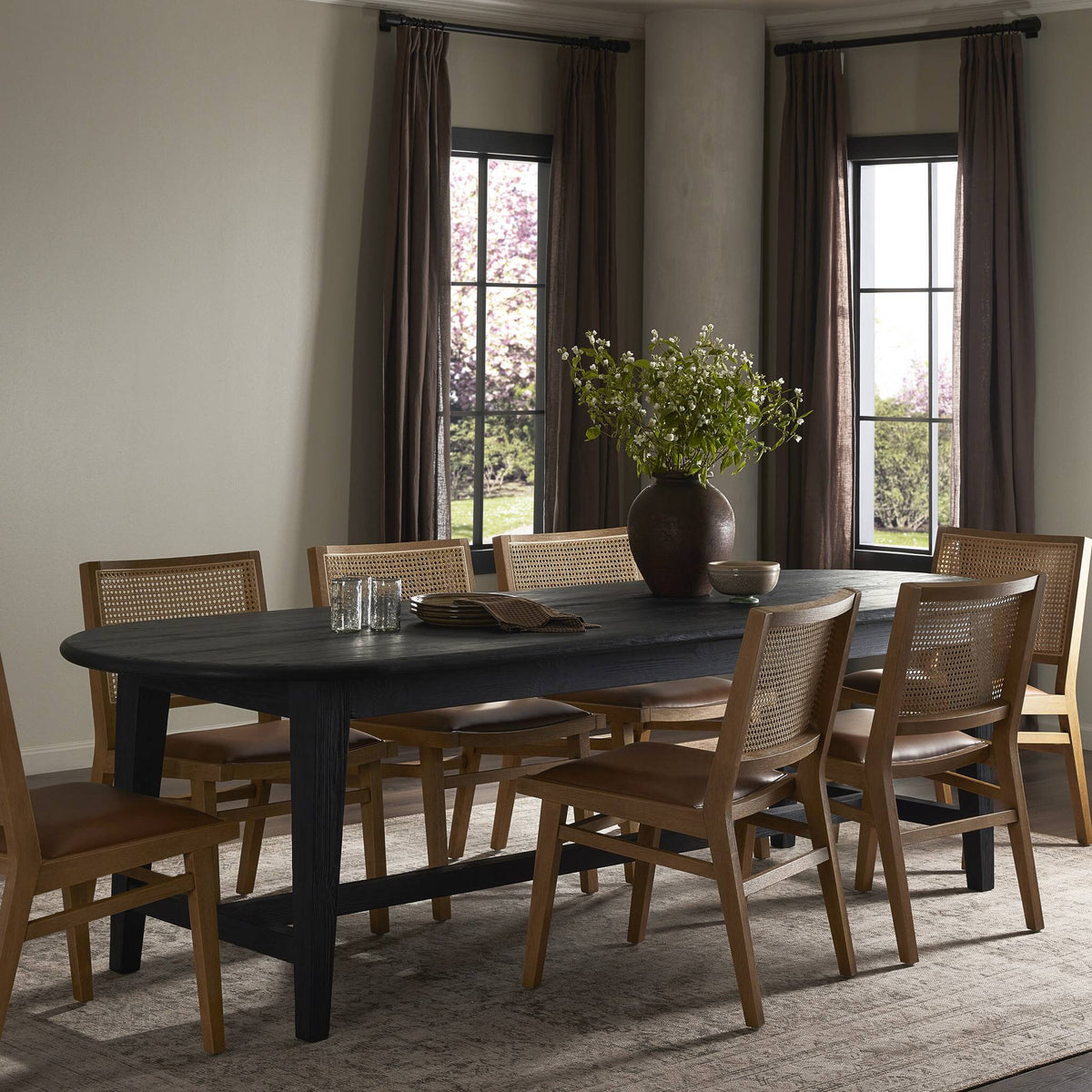 Savona Dining Table in black pine with a sleek, contemporary design in a stylish dining room.