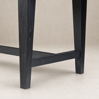 Close-up of the Savona Dining Table in black pine, highlighting its sturdy legs and sleek finish.