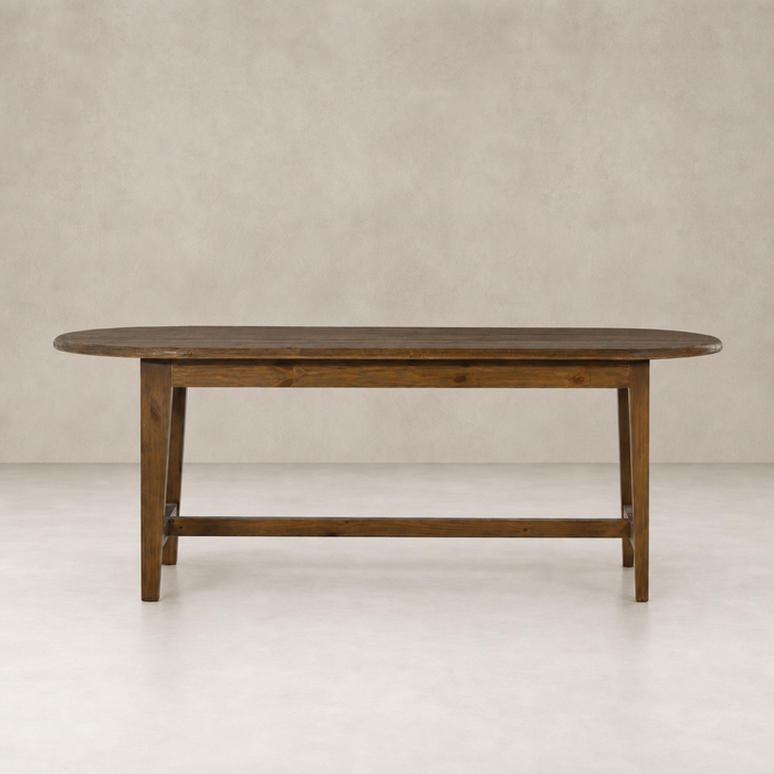 Savona Dining Table in waxed pine with an oval shape and sturdy legs.