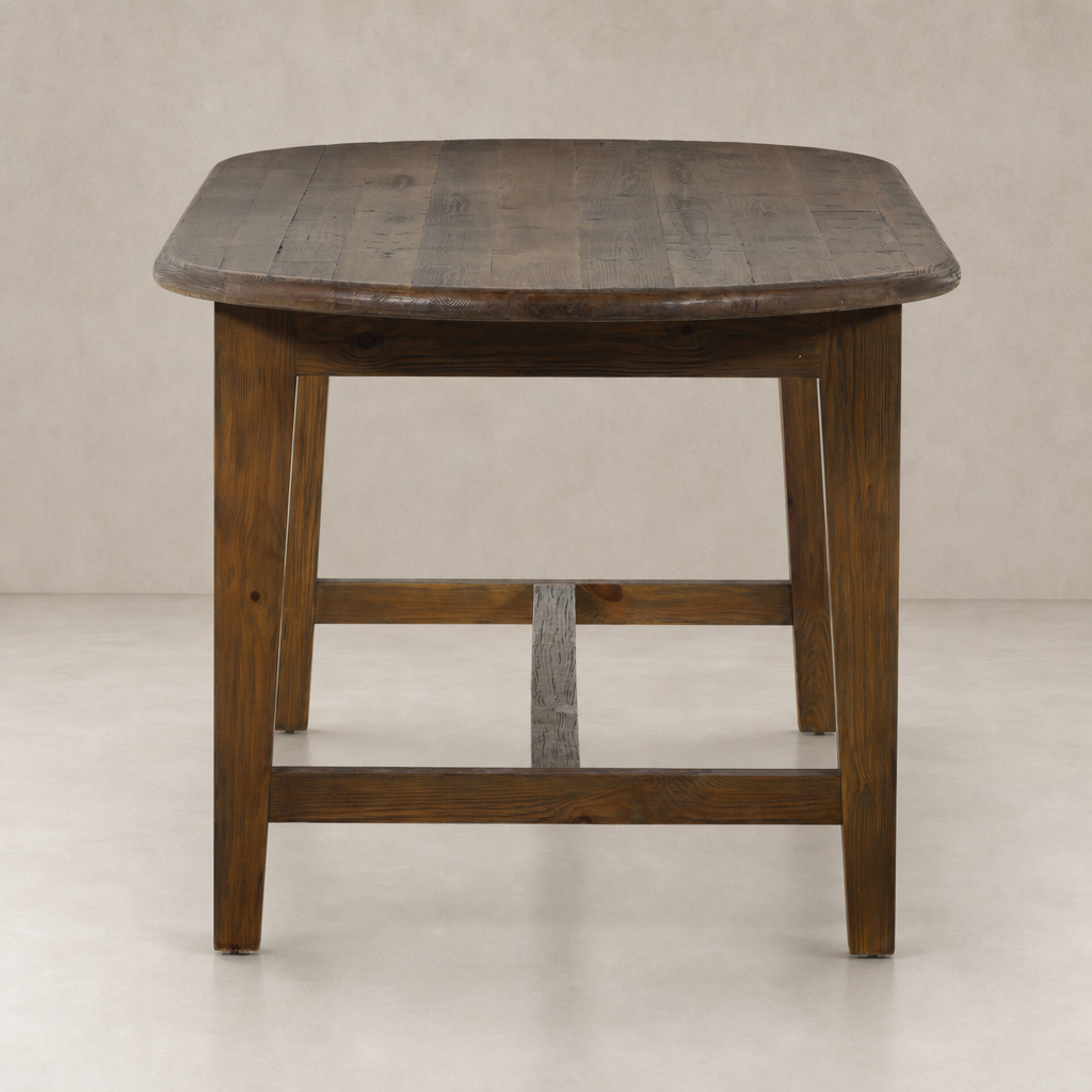 Savona Dining Table in waxed pine featuring a rounded top and sturdy legs.