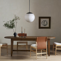 Savona Dining Table in waxed pine, featuring a smooth, oval shape and rustic finish.