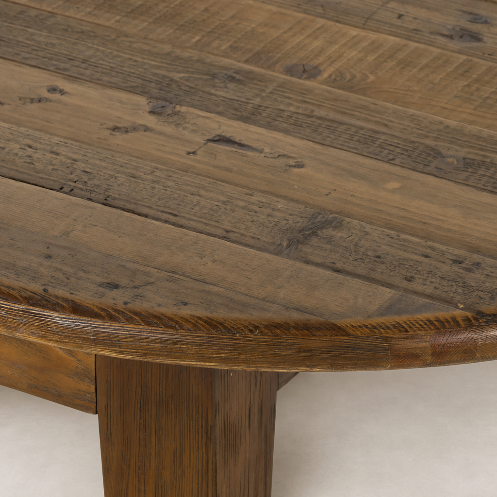 Savona Dining Table with a round top made of waxed pine showcasing rich textures.