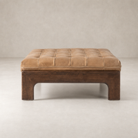 Hudson Cocktail Ottoman in Palermo Drift with tufted leather top and wooden base.