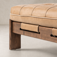 Hudson Cocktail Ottoman in Palermo Drift with tufted leather cushion and wooden base.