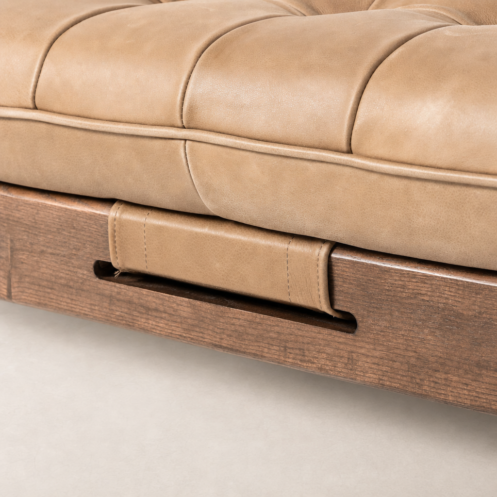 Close-up of Hudson Cocktail Ottoman in Palermo Drift with tufted leather seat and wood base.