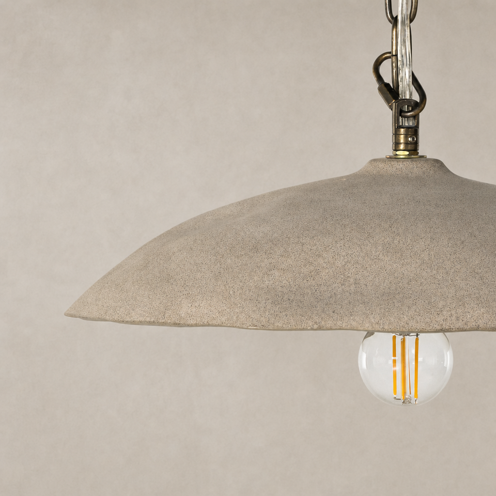 Light sand porcelain ceramic pendant with a smooth, curved shade and visible light bulb.