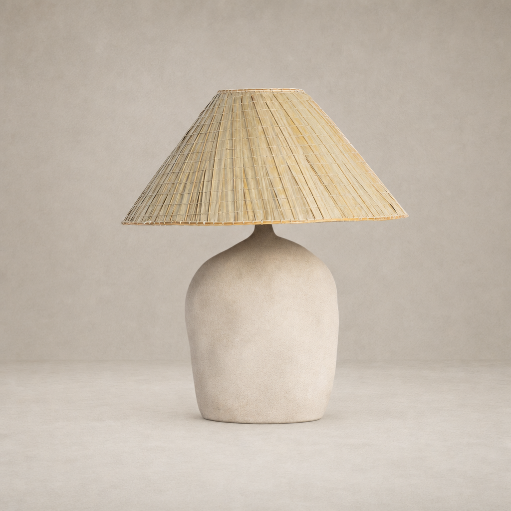 Sand porcelain table lamp with a textured base and woven straw shade.